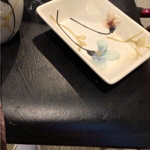 Beautiful ceramic soap dish with design and matching drinking cup for bathroom